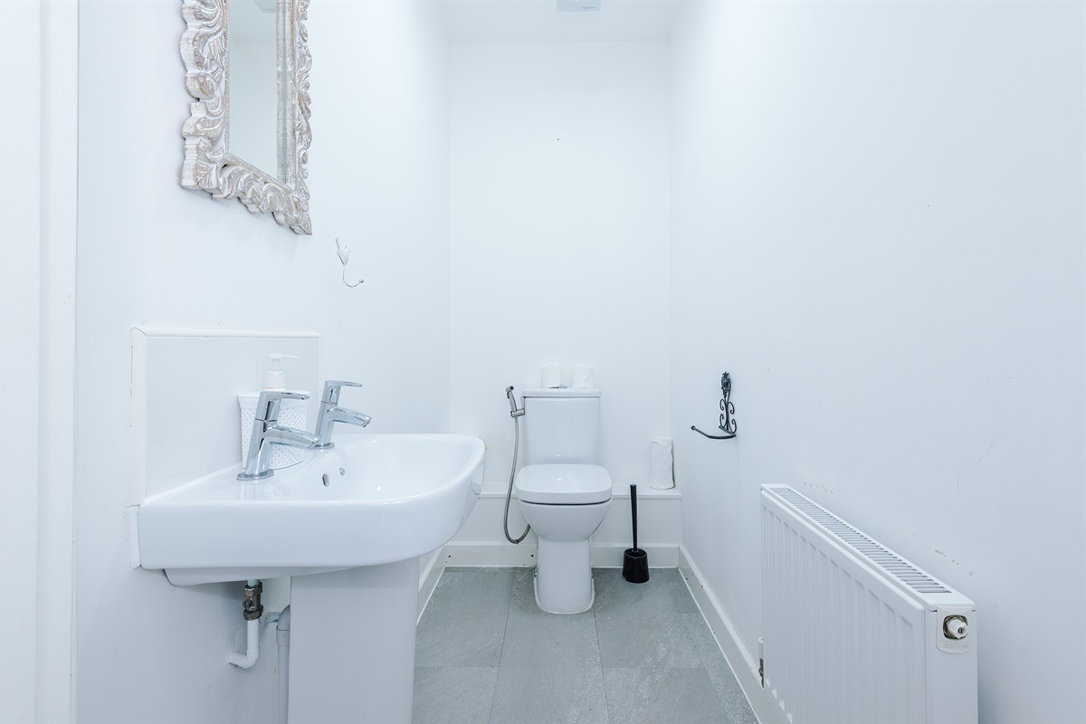 Downstairs WC benefits from a bidet, toilet and basin