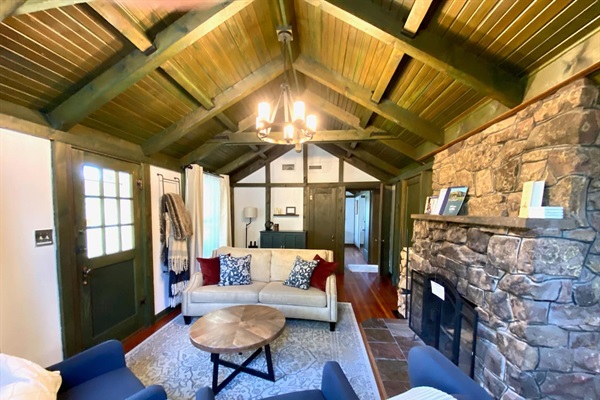 Living room with large stone fireplace.  This portion of the home is 100 years old and all original! 