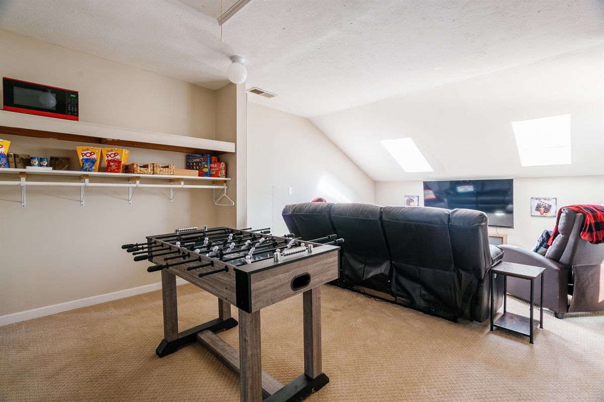 Theater room for family movie night & foosball table