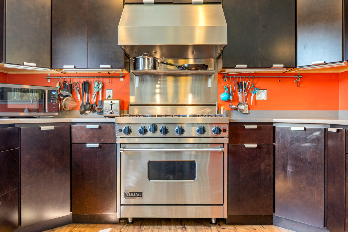 Built for culinary enthusiasts: "The Crag's" Social Heart kitchen features a commercial-grade Viking gas range, professional stainless hood, and fully stocked utensil racks. High-performance design ready for post-hike group meals.