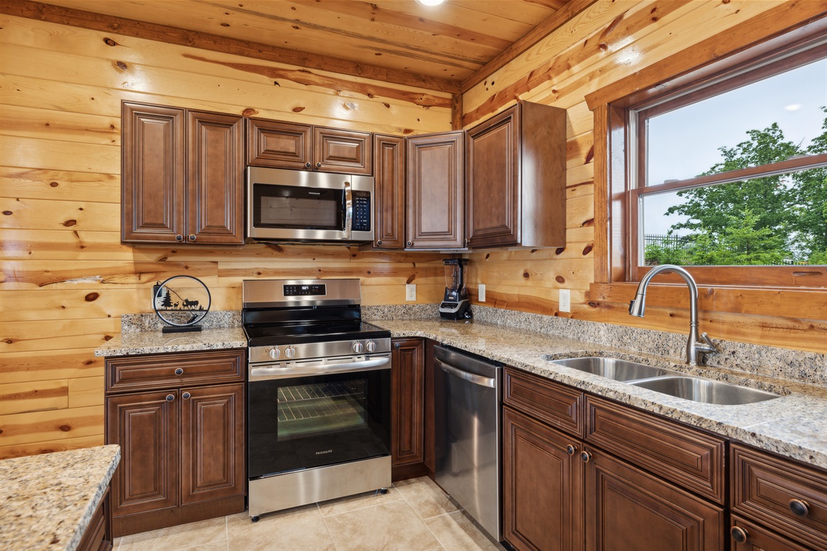 Fully equipped chef’s kitchen with granite countertops and bar seating.