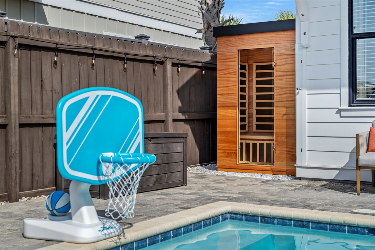 Pool basketball for the kids, sauna for the adults. Cool off in the pool, then relax and recharge after a day at Miramar Beach. A backyard designed for fun and relaxation.