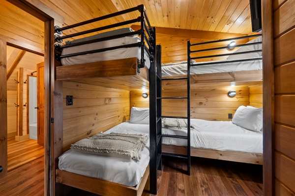 Connected Bunk and Queen Bedrooms with Barn Door, TV, Individual Reading Lights, and USB Charging at Each Bunk.