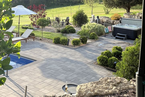 The gardens are a labor of love, and guests notice. Quiet hilltop in front, rolling Galena hills beyond.
