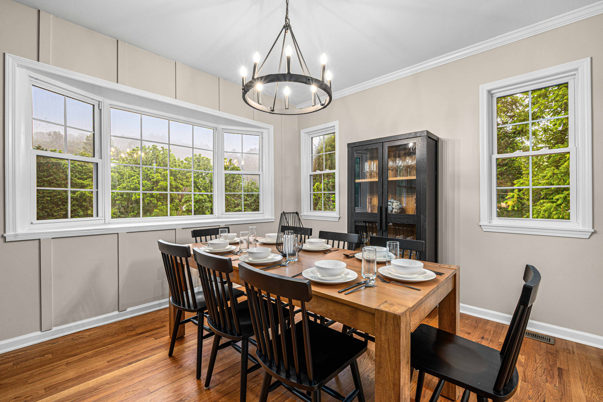 Gather around the elegant table with views of nature and bright, inviting light!
