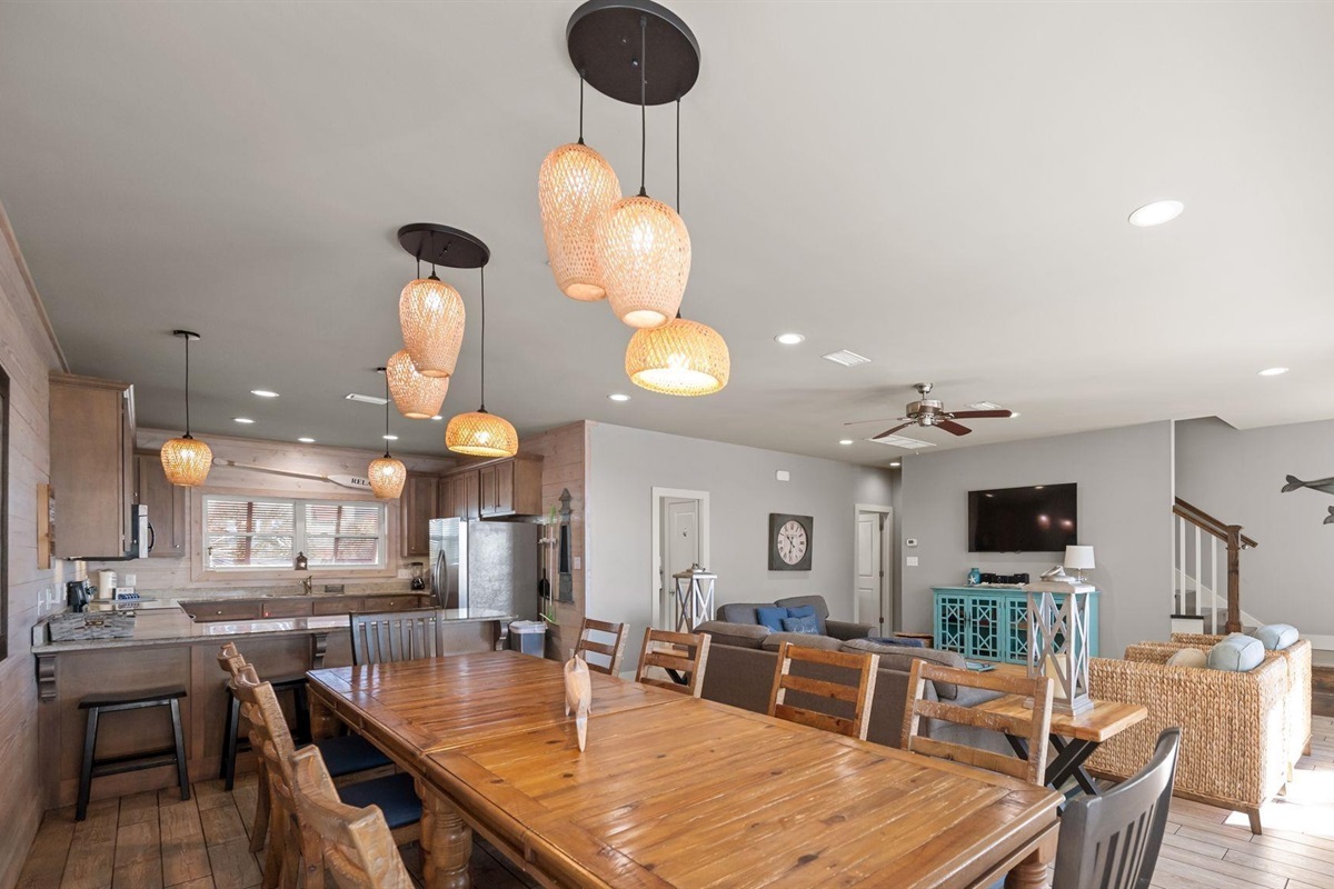Dining area with a table and chairs set for 8 and additional seating for 4 at the breakfast bar 
