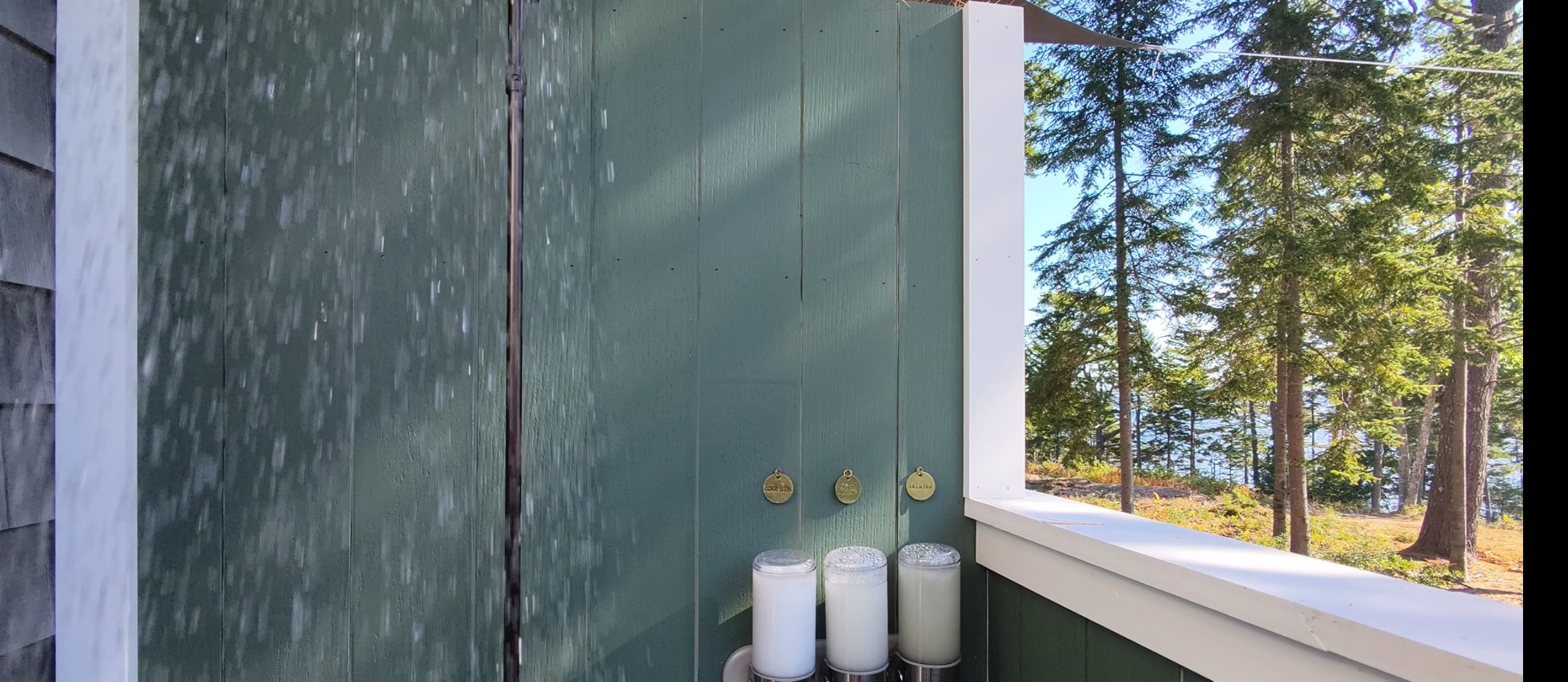 Bunkhouse boasts 1 of 2 outdoor showers with stunning harbor views which are accessed privately from each bath. 