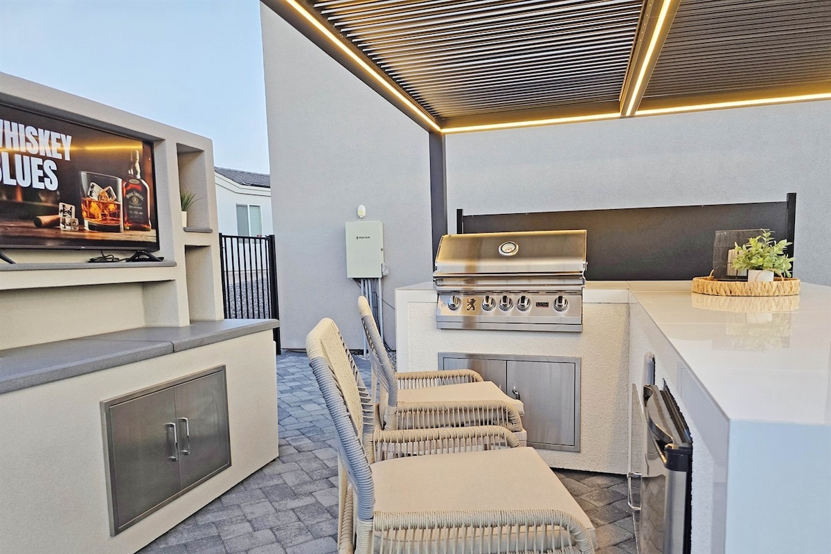 Outdoor kitchen and lounge w/ Lion BBQ.