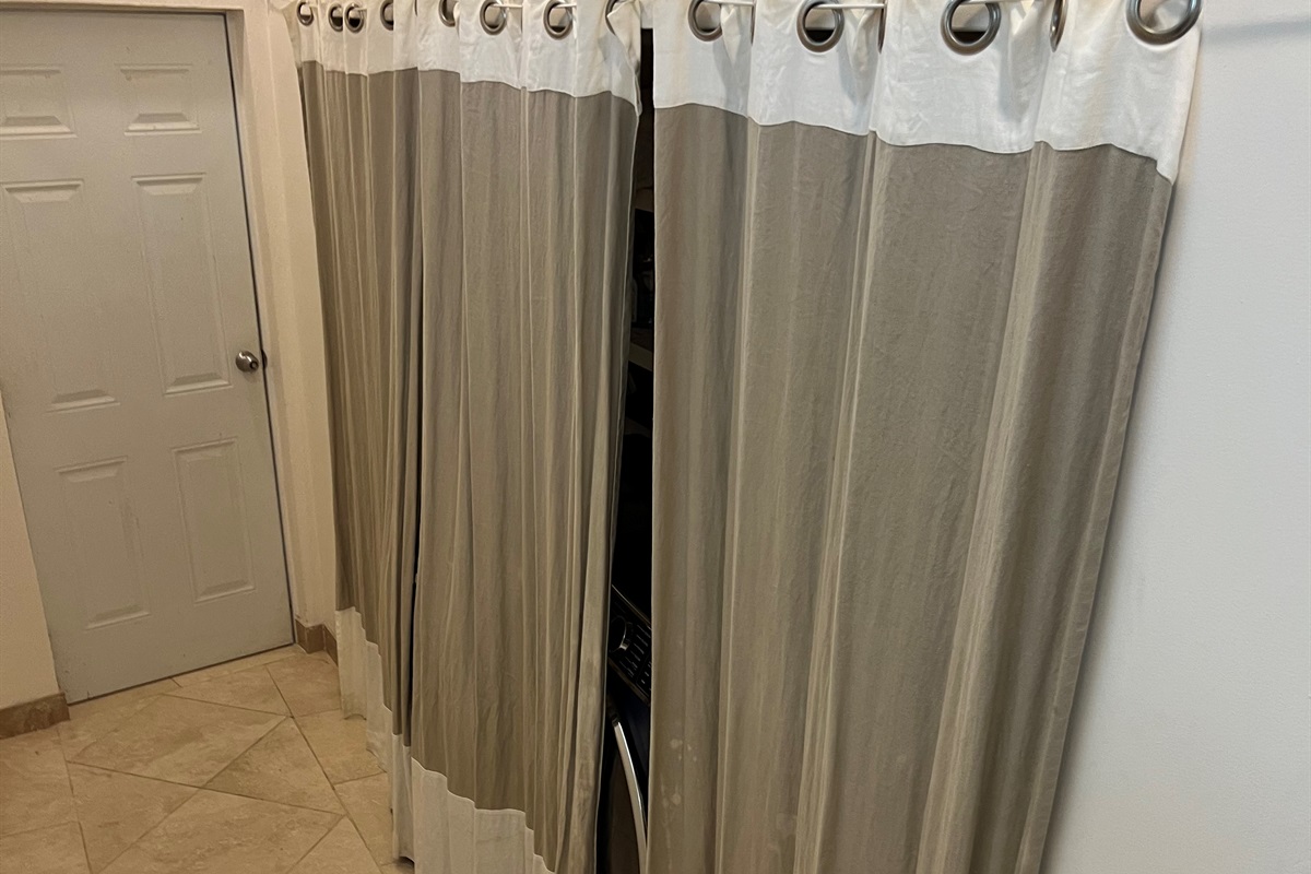 Behind the curtains are the washer and dryer.