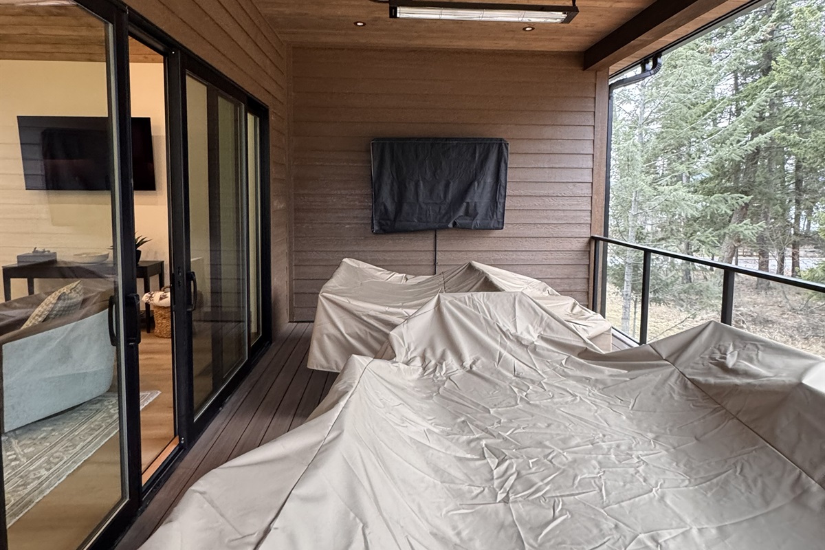 Back deck with a TV, heaters for the winter chill, fans for the summer heat, a bar-b-q, and a flat top!