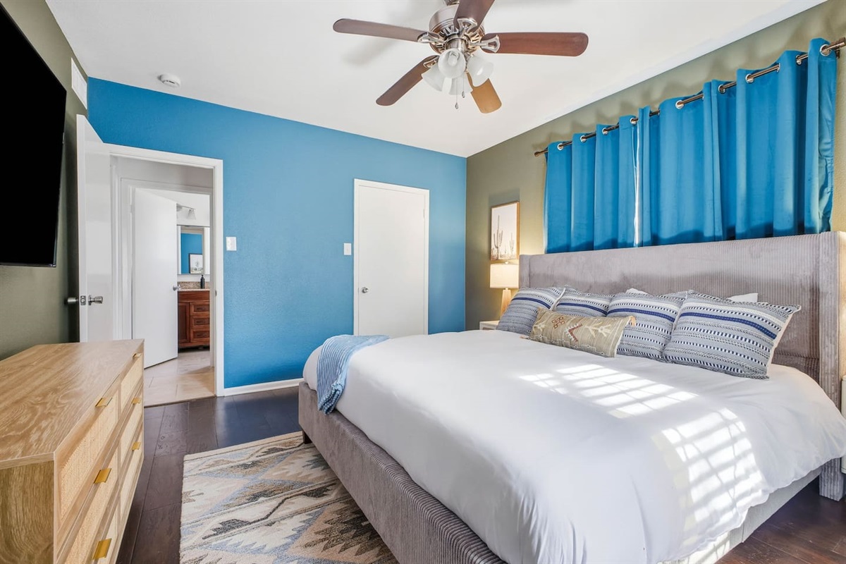 First-floor bedroom with king bed and Roku TV; bathroom just behind, usable as an en-suite or shared