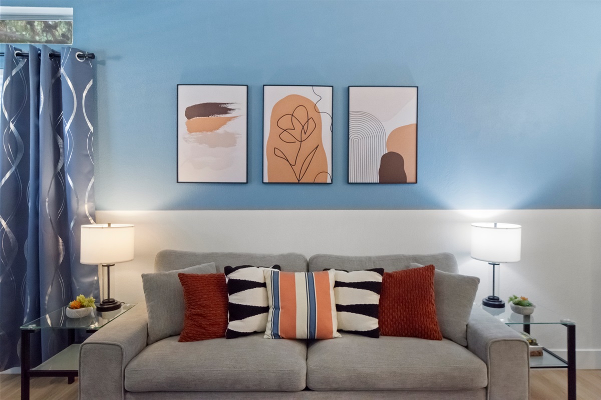Enjoy a beautifully designed living room that highlights comfort and relaxation, featuring a soft, comfortable sofa perfect for lounging at any time of the day.