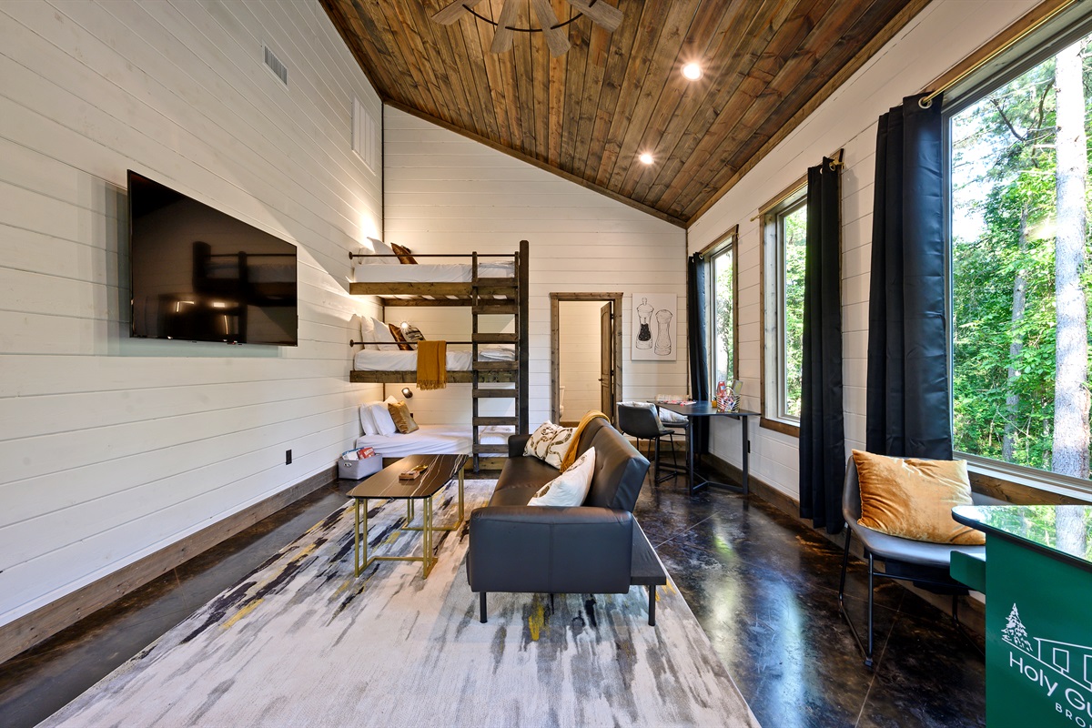 Bunk room with bunk beds and sleeper sofa with outdoor views