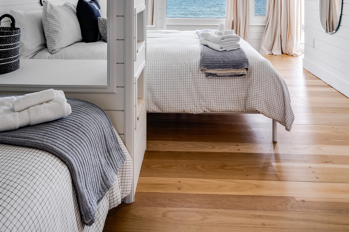 Bedroom with 3 twins, and 1 Queen bed. 