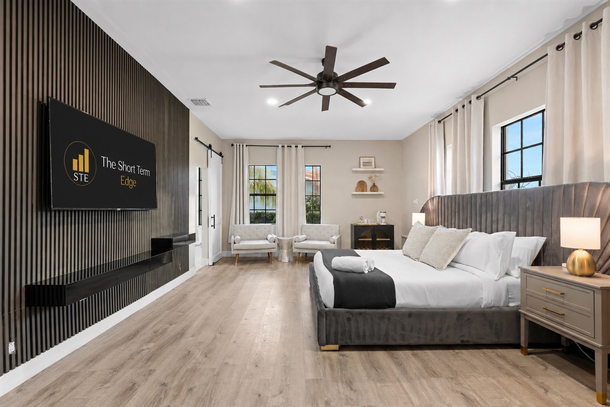 🛌 Downstairs master suite with 65" TV, cozy chairs, and your own coffee station to start off each day.