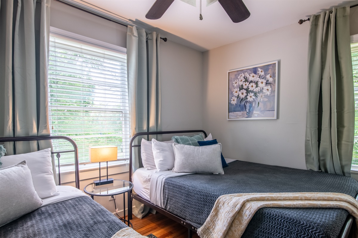 Another view of the twin bedroom, showcasing thoughtful decor and a peaceful setup.