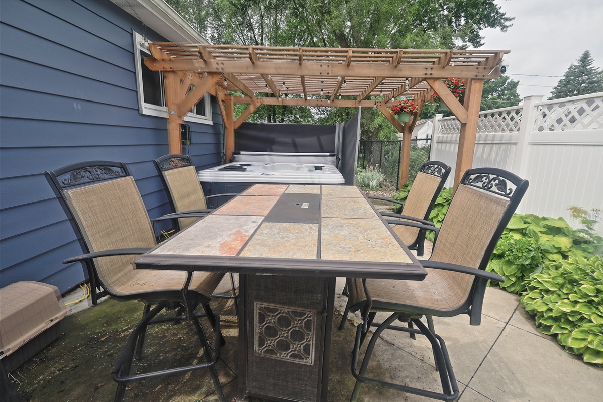 The patio with pergola, fire table and hot tub
