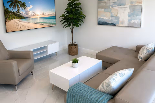 Bright, modern living room with comfortable seating, a large smart TV, and a relaxing coastal feel.