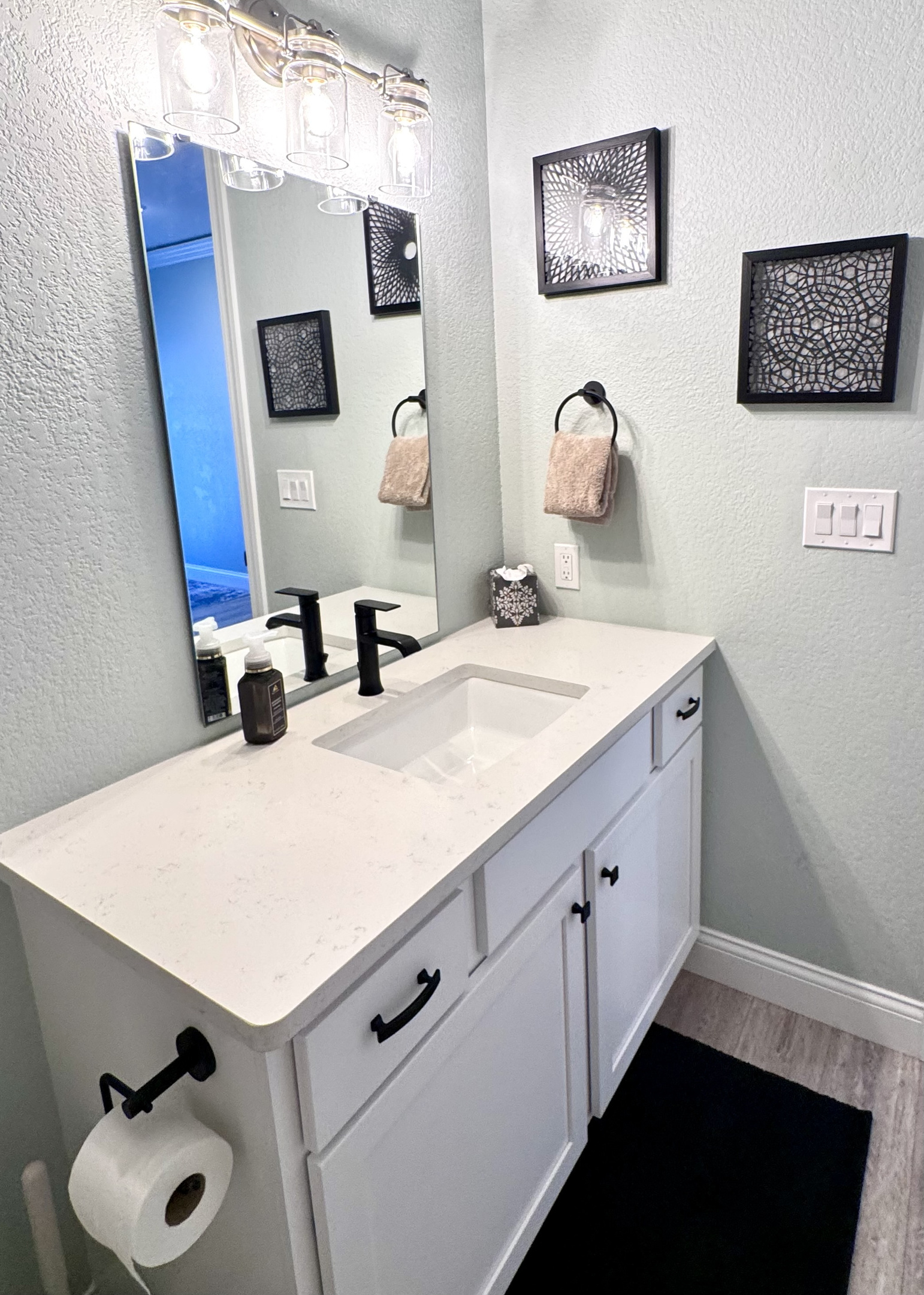Bathroom 2 with an extended sink top and tub shower combo.