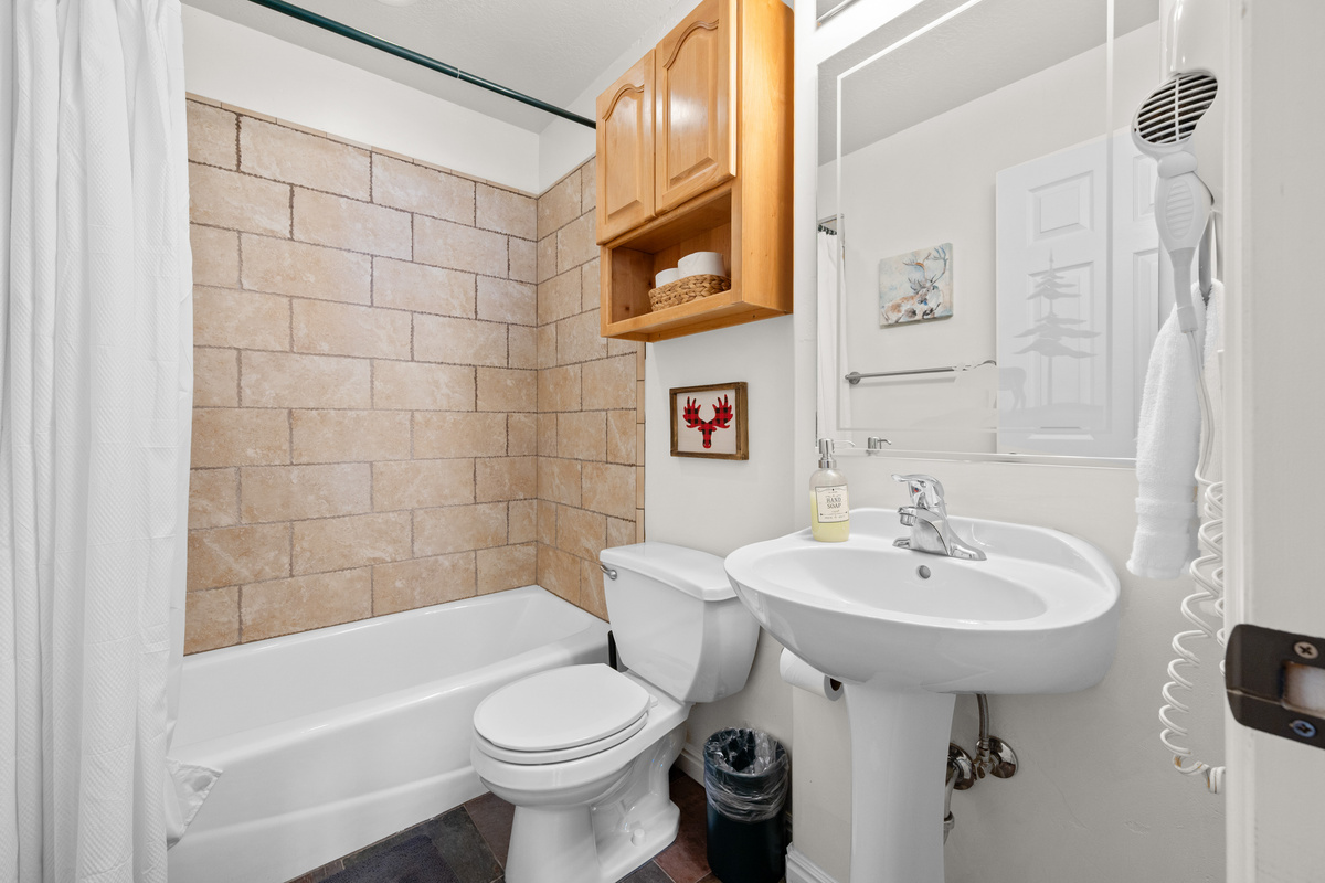 You’ll find a full bathroom designed for comfort and convenience. It features a tub/shower combination—perfect for a relaxing soak or a quick rinse after a day spent outdoors