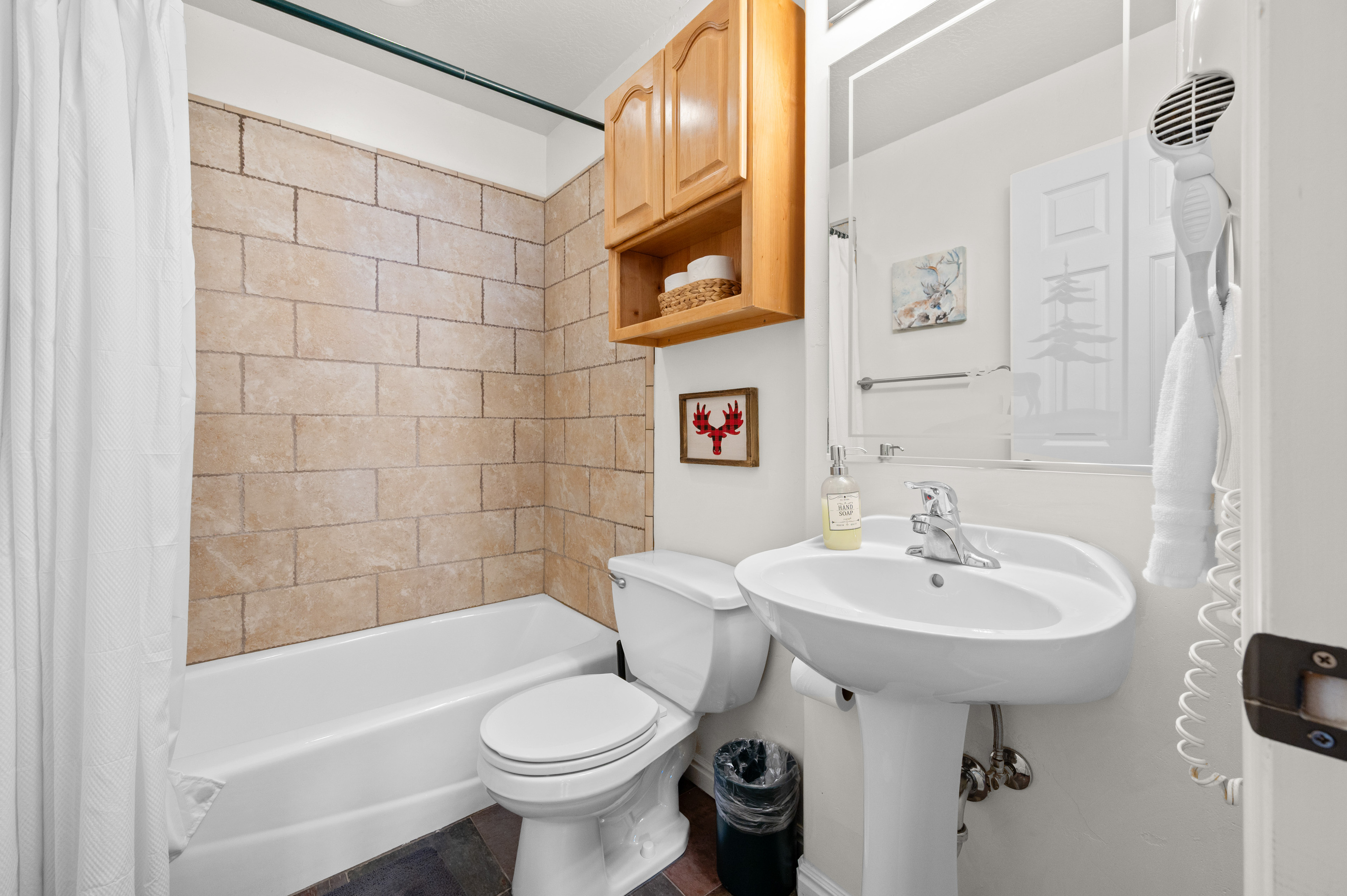 You’ll find a full bathroom designed for comfort and convenience. It features a tub/shower combination—perfect for a relaxing soak or a quick rinse after a day spent outdoors