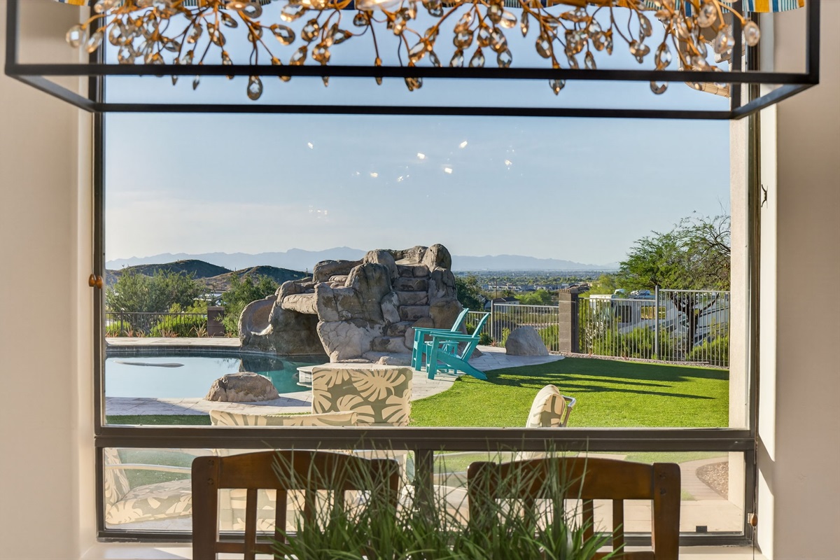 Dining area overlooking the pool and desert landscape — enjoy meals with unforgettable backyard views