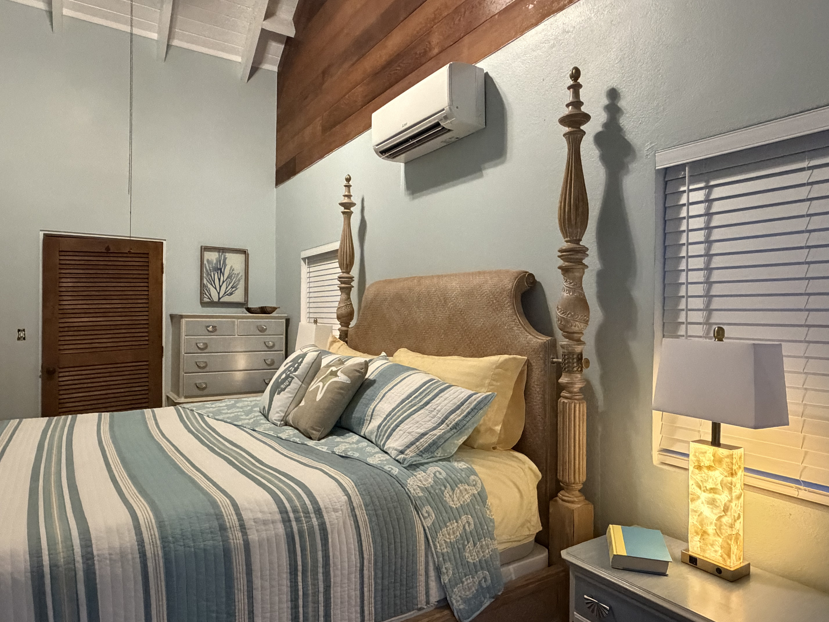 Featuring a grand four-poster king bed, soft bedding, AC, and classic terracotta tile floors, this peaceful suite offers a refined beachside retreat.
