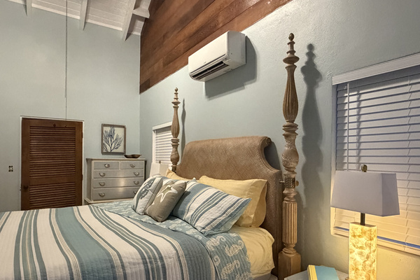 Featuring a grand four-poster king bed, soft bedding, AC, and classic terracotta tile floors, this peaceful suite offers a refined beachside retreat.