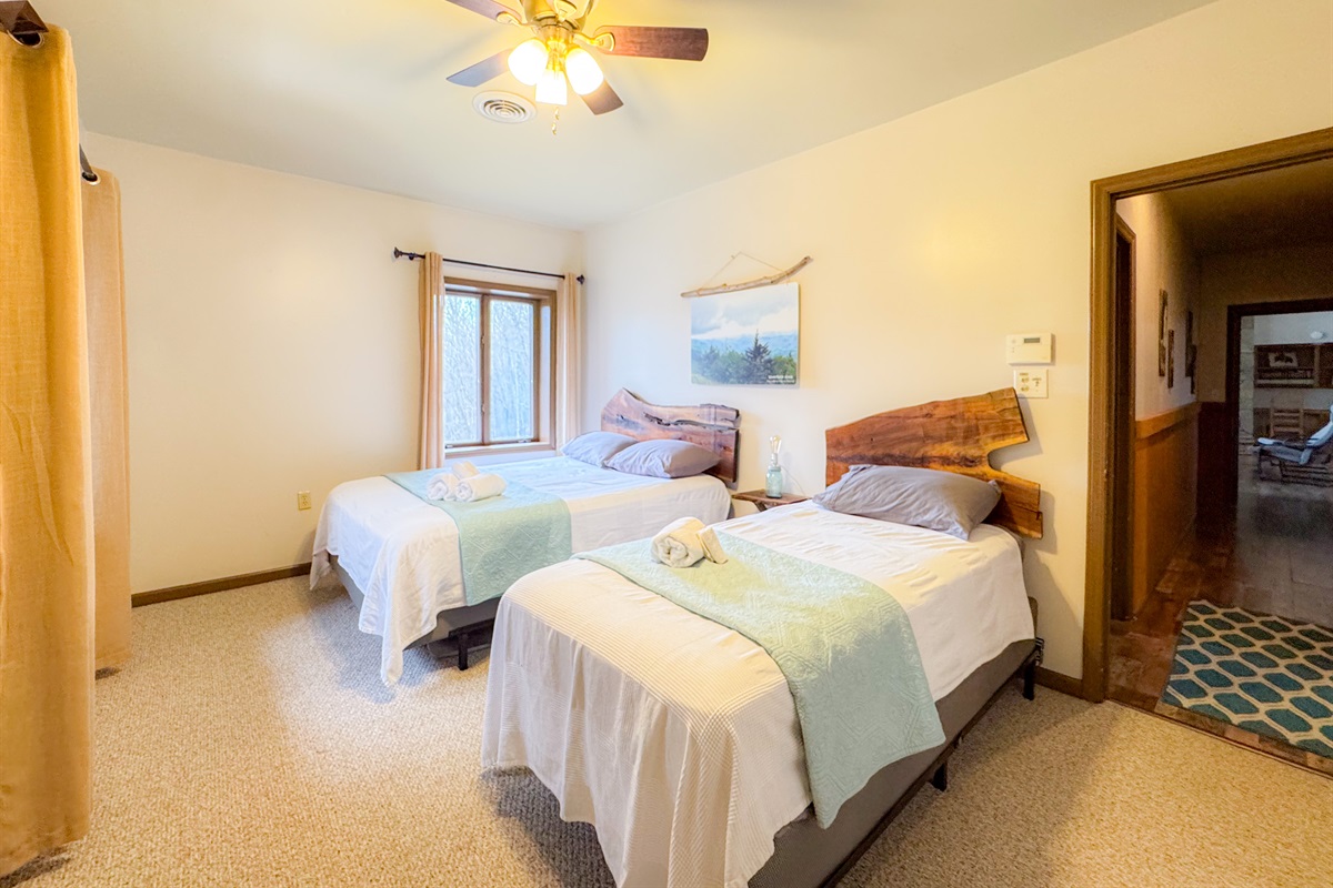 our Waterrock Knob themed bedroom features a queen and twin bed on the upper level. The bedroom overlooks Waterrock Knob in the distance.