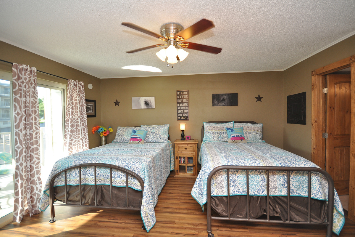 Primary bedroom has two full size beds.