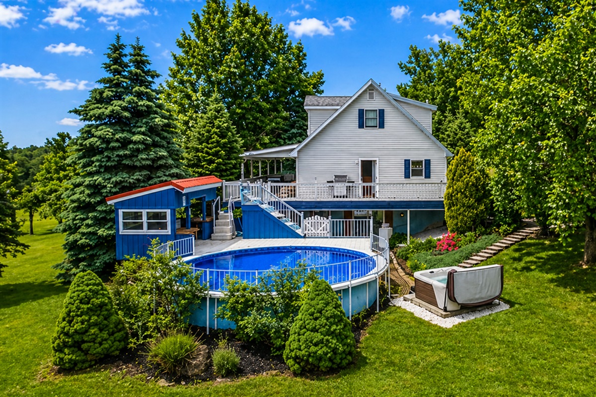 Enjoy a refreshing dip in the private pool surrounded by lush greenery and a cozy outdoor area.