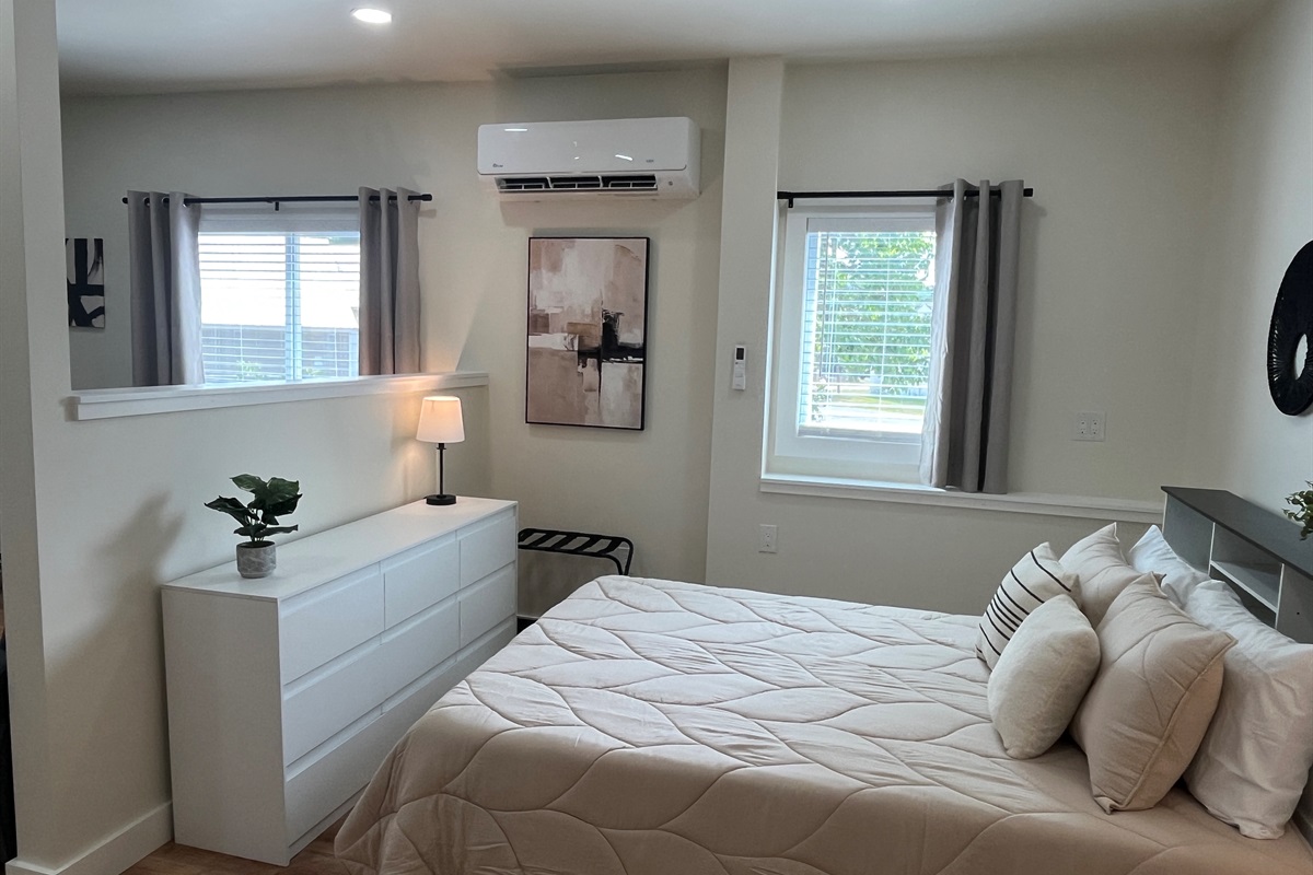 Queen sleeping area with wall-mounted mini-split