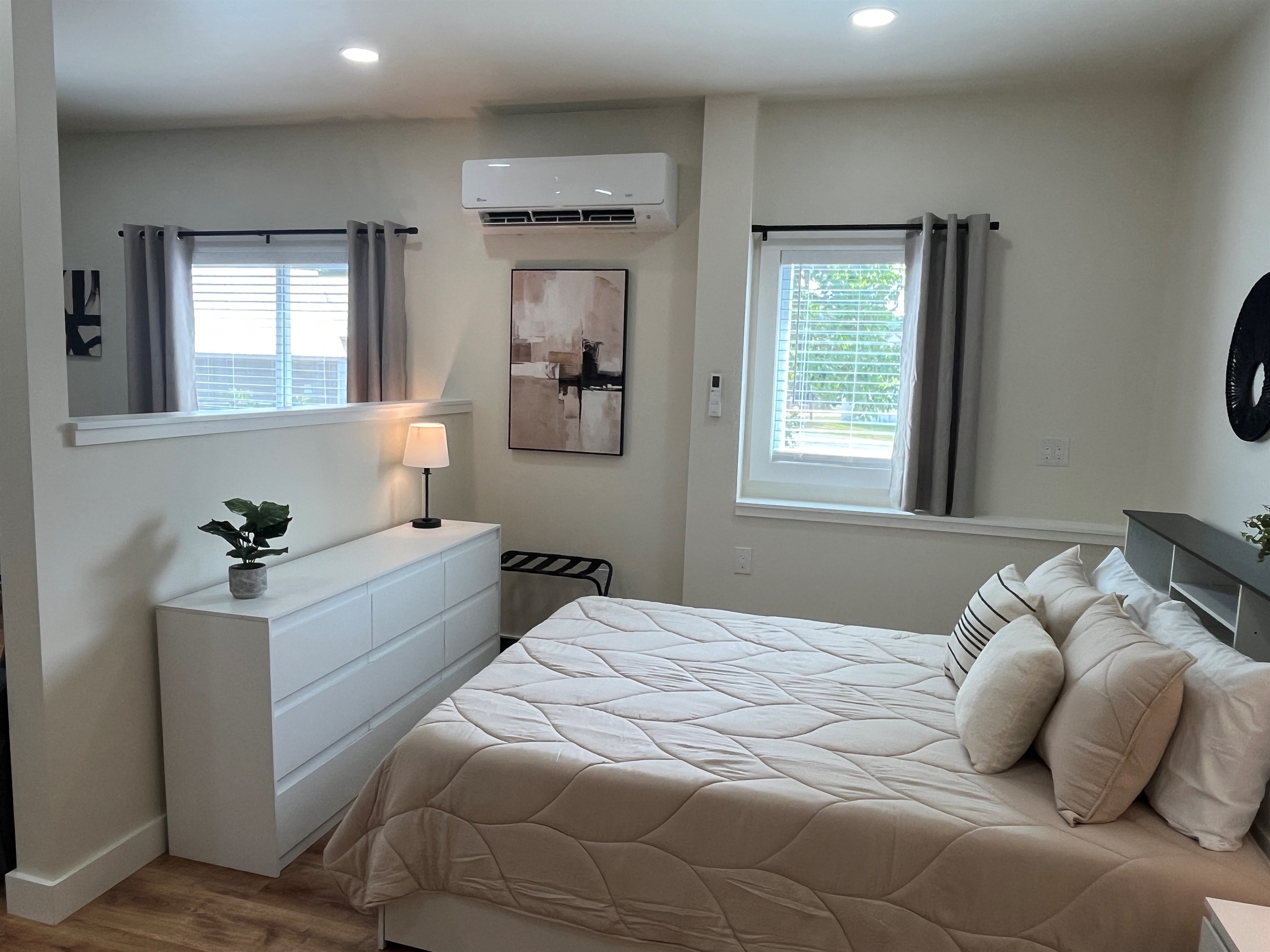 Queen sleeping area with wall-mounted mini-split