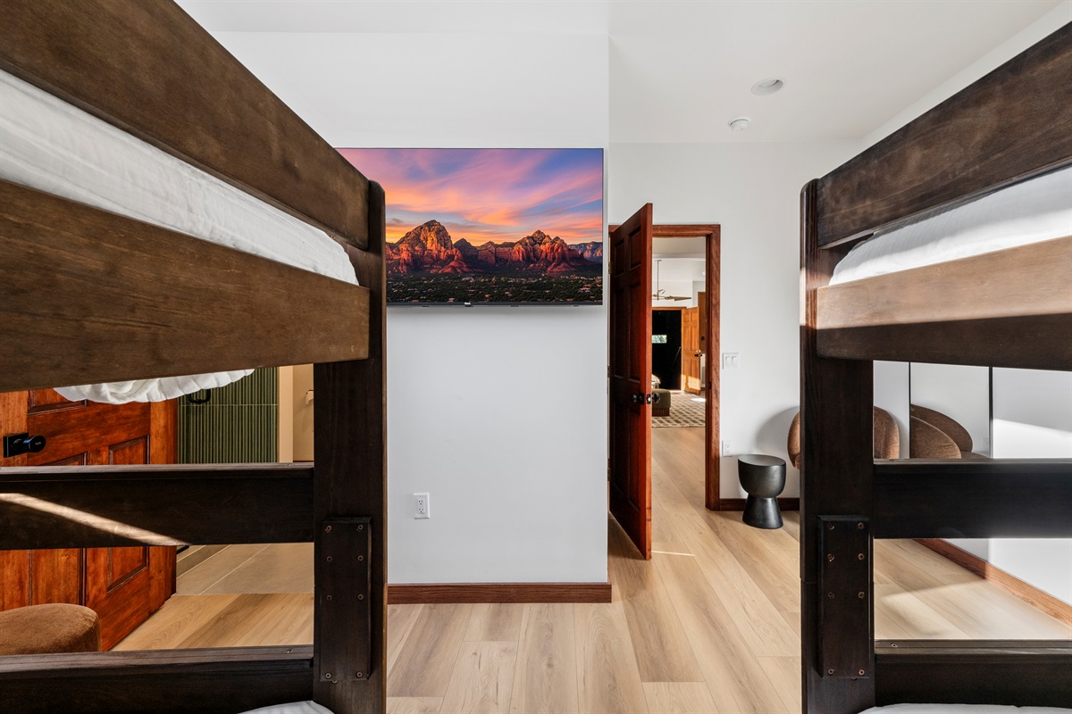 Bright bunk room with queen-over-queen beds and stylish finishes.