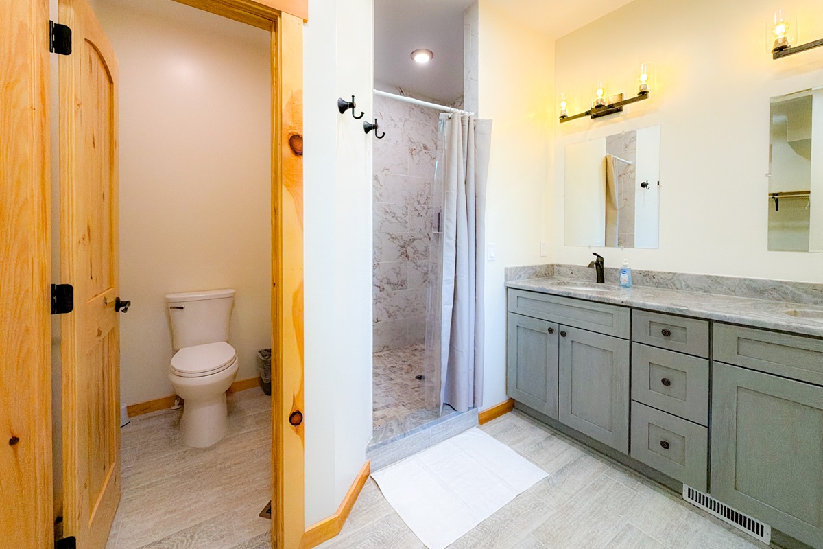 The Master Bathroom features double vanity sinks, large tile shower, and a separate space for the toilet.