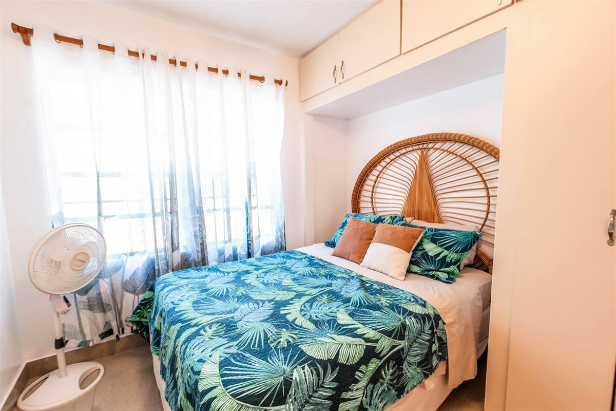 Open the windows to feel the cool Caribbean breeze indoors in this queen bedroom. The fan is provided in addition to the breezes.  