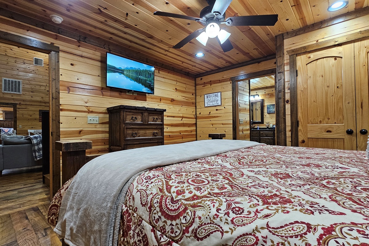 Bedroom 2: Rustic charm with wooden accents and plush bedding for a perfect getaway!