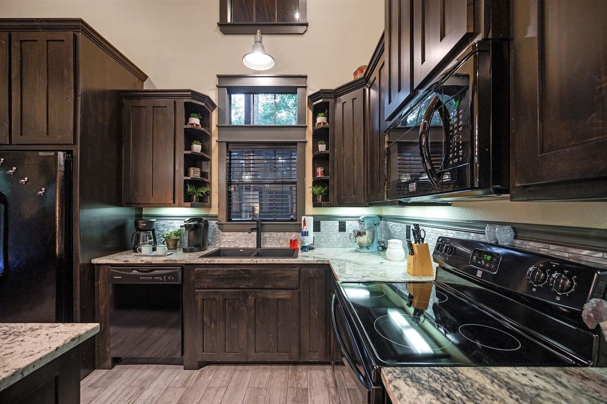 Enjoy a fully equipped kitchen featuring granite counters, modern appliances, and thoughtful touches like foil, oil, and seasonings.