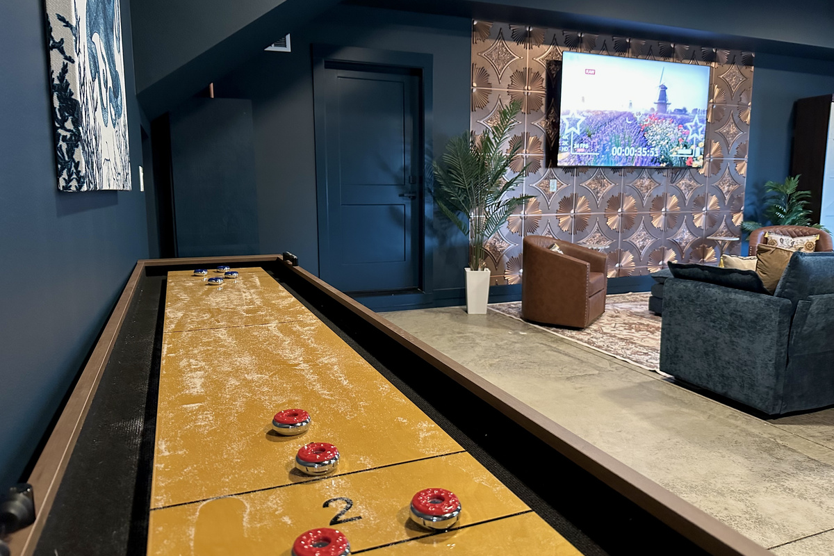 Call your shot and let the pucks fly — shuffleboard runs all weekend in the speakeasy while the game plays on the wall behind you.