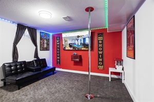 A cozy space outfitted with a comfortable couch, popcorn maker, dance pool area, and TV for the perfect blend of relaxation and entertainment.