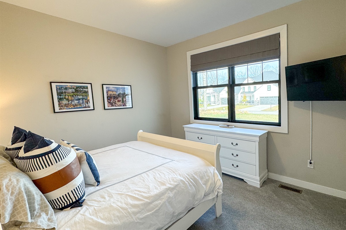 Guest bedroom with queen bed and tv with streaming.