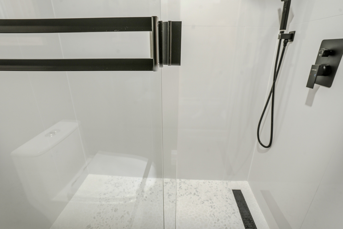 Walk-in shower with rainfall head and large-format tile — spa-quality finish