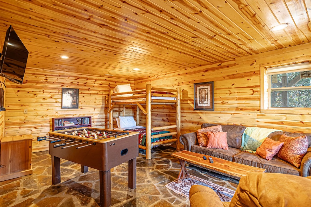 Lower level open living room/ bunk bed room with French Doors to lower, fully enclosed deck. The lower deck also has a gate for entry/exit from lower level.