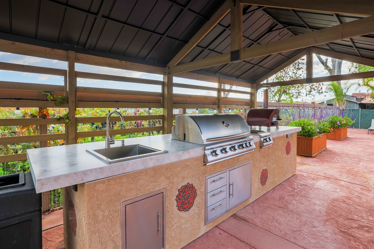 Our new outdoor kitchen, including covered BBQ, sink, and pizza oven.