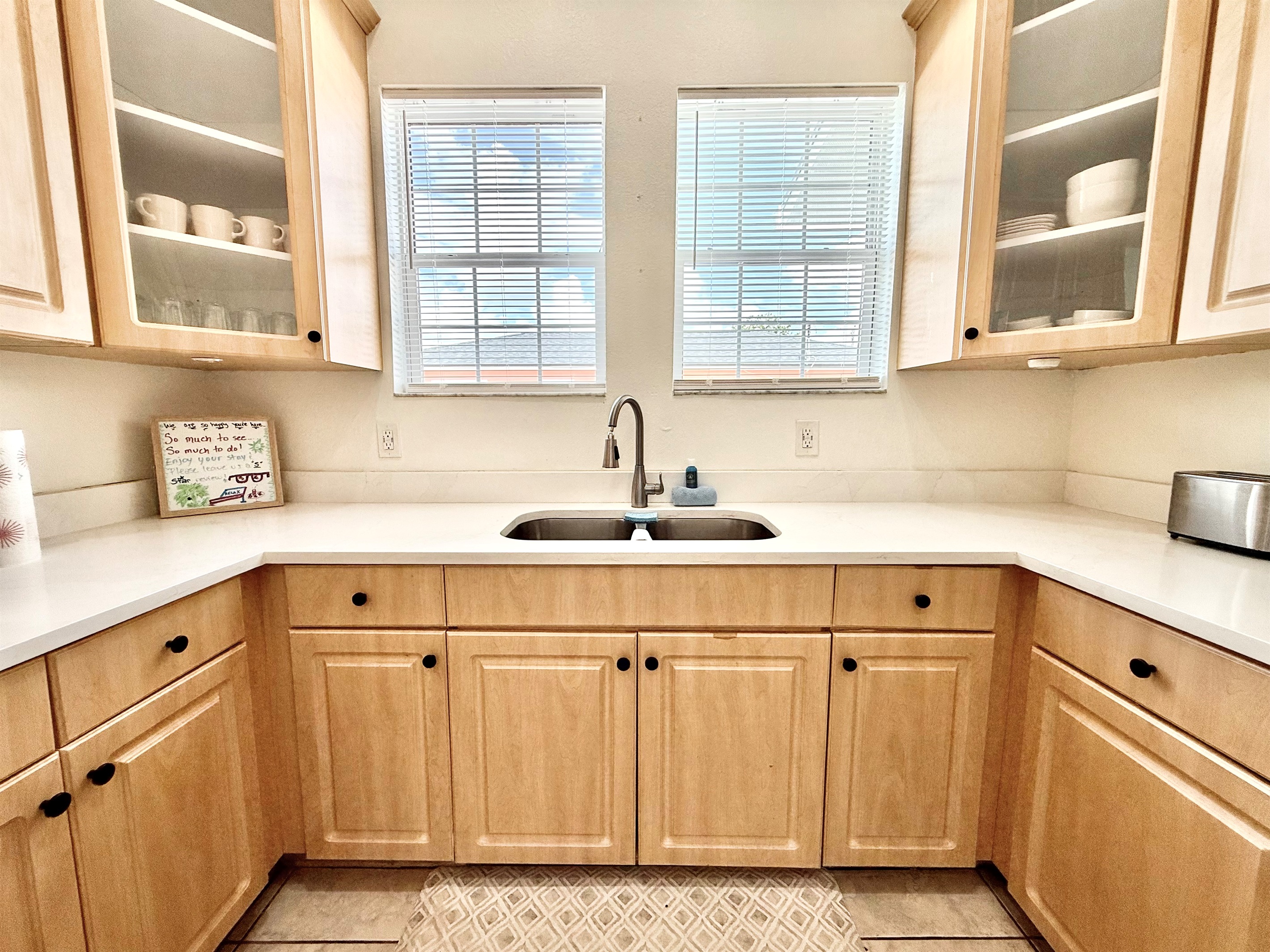 Airy and modern with subtle farmhouse flair—this kitchen’s warm tones and natural light make it a joy to cook in.