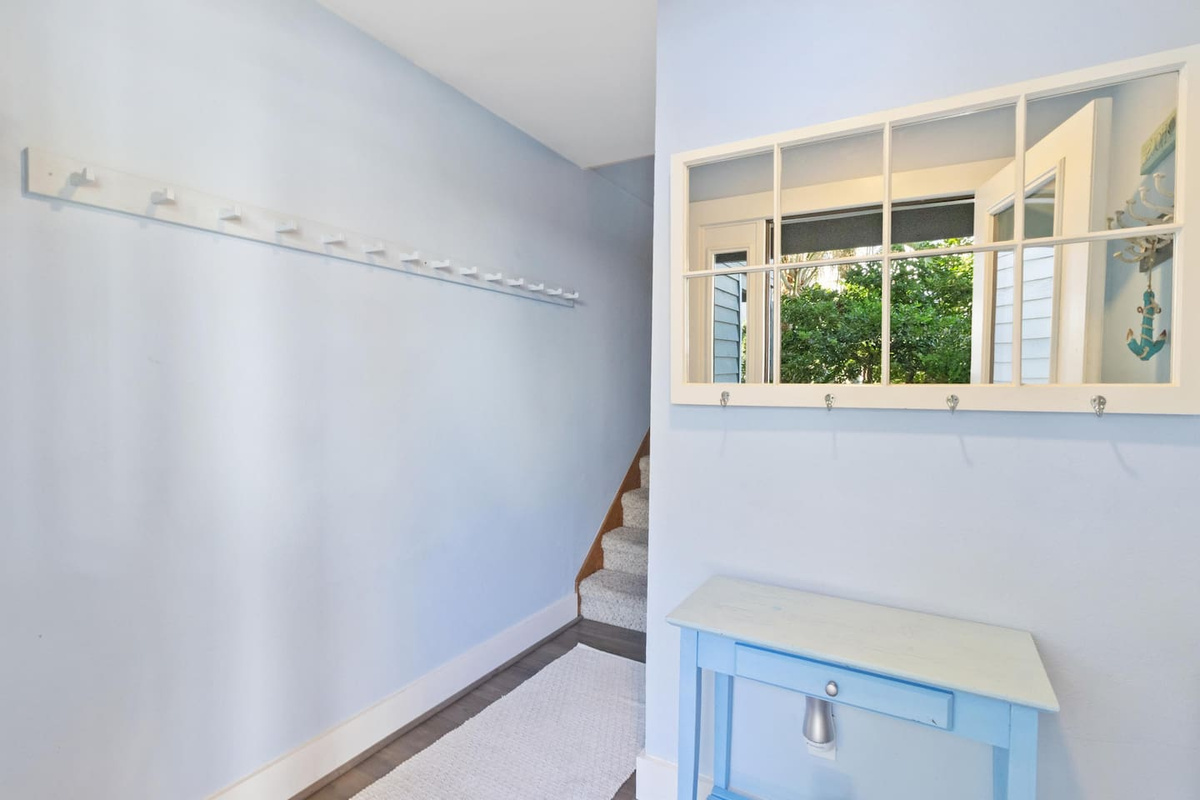 Your carpeted stairs lead up from the foyer to the main living level &mdash; easy on bare feet after a long beach day.	
