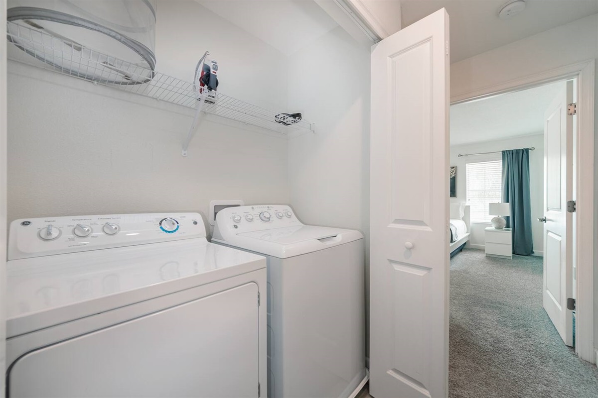 The laundry room, with a high capacity washer and a dryer, is inside the closet that is in the hallway upstairs 