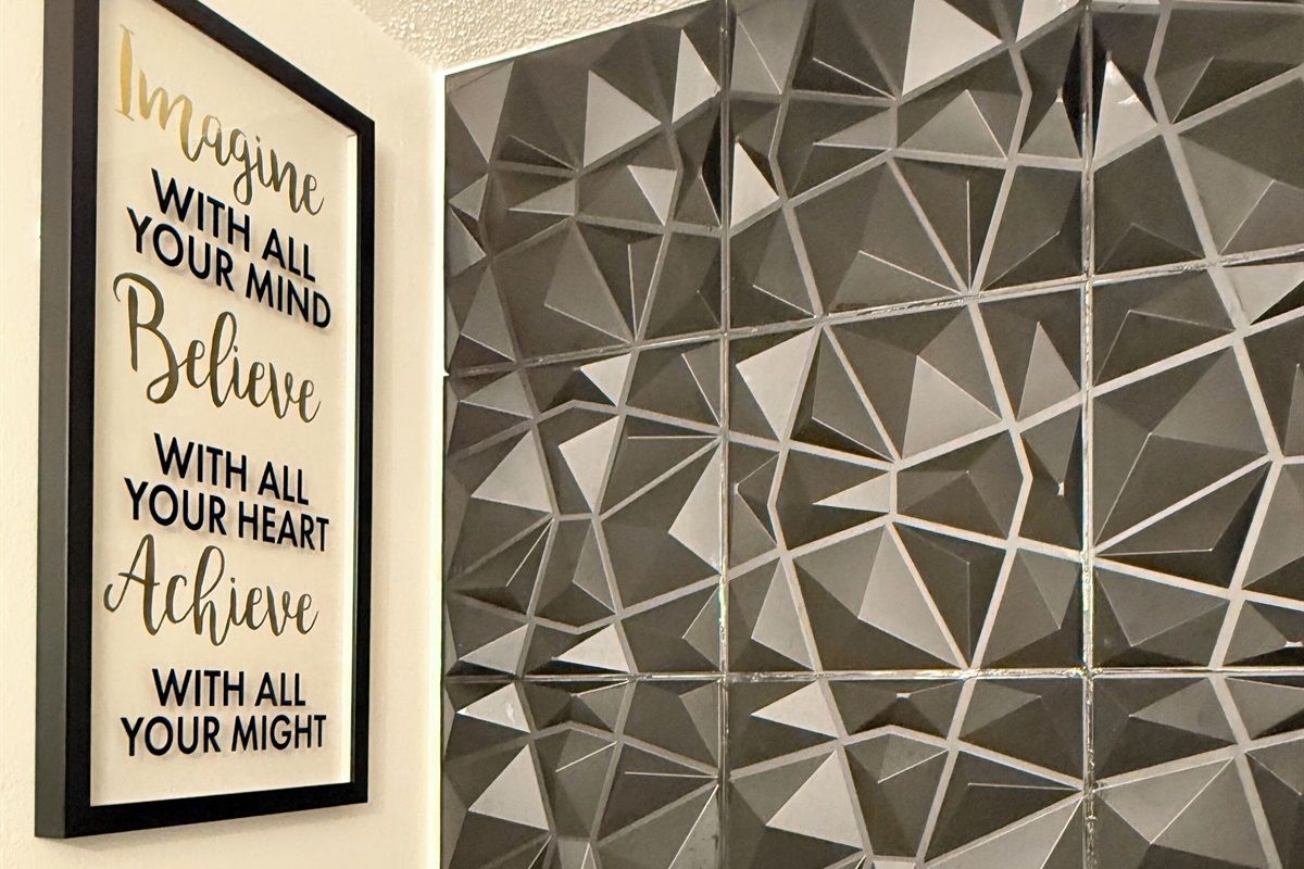 Uplifting wall quote paired with textured tile — small details that make a big impression. 