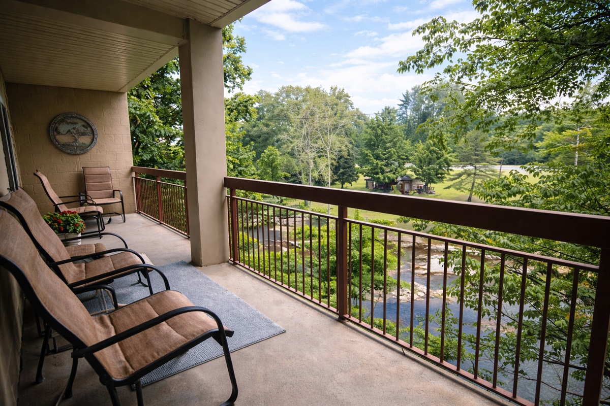 Private creekside balcony overlooking the river — enjoy peaceful Smoky Mountain mornings with coffee right In downtown Pigeon Forge.