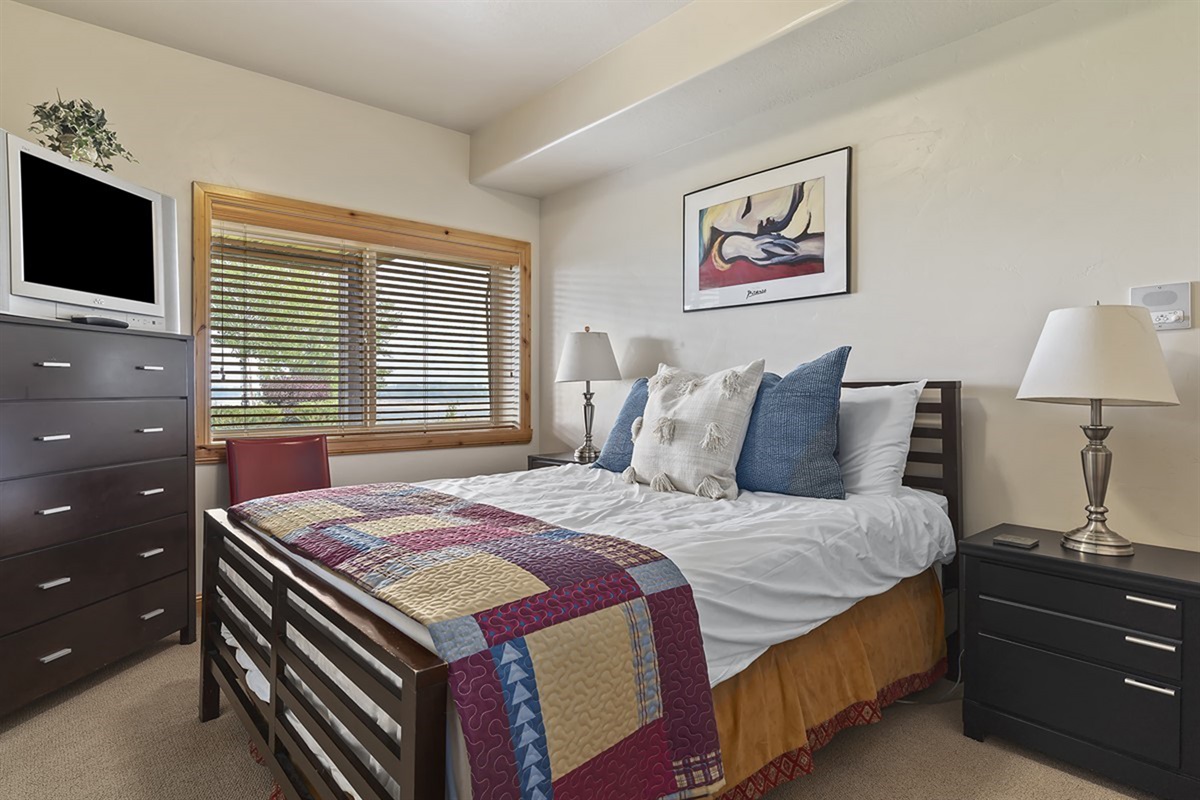Comfortable guest bedroom with tasteful décor and ample natural light—perfect for a restful stay.